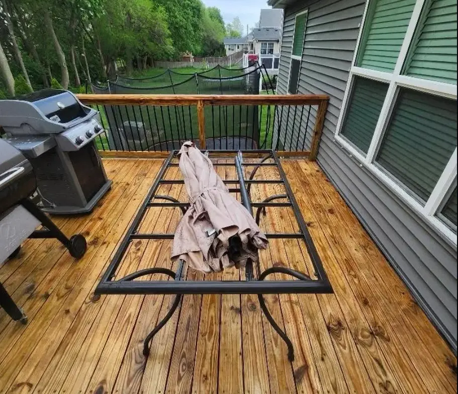 Wooden deck with clean golden boards after pressure washing